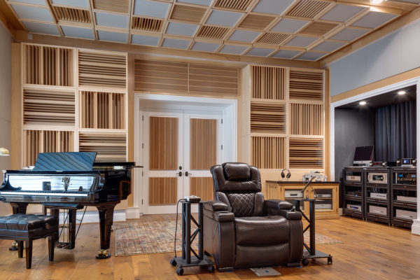 acoustically treated listening room with seat, piano and sound diffusers on the walls