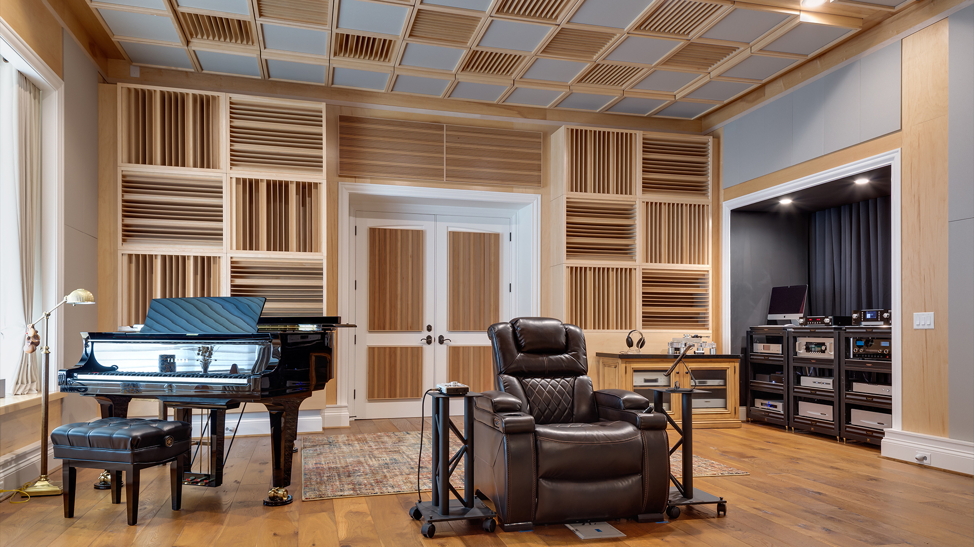 acoustically treated listening room with seat, piano and sound diffusers on the walls