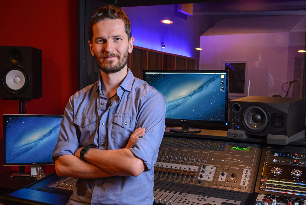 man standing in front of recording studio window